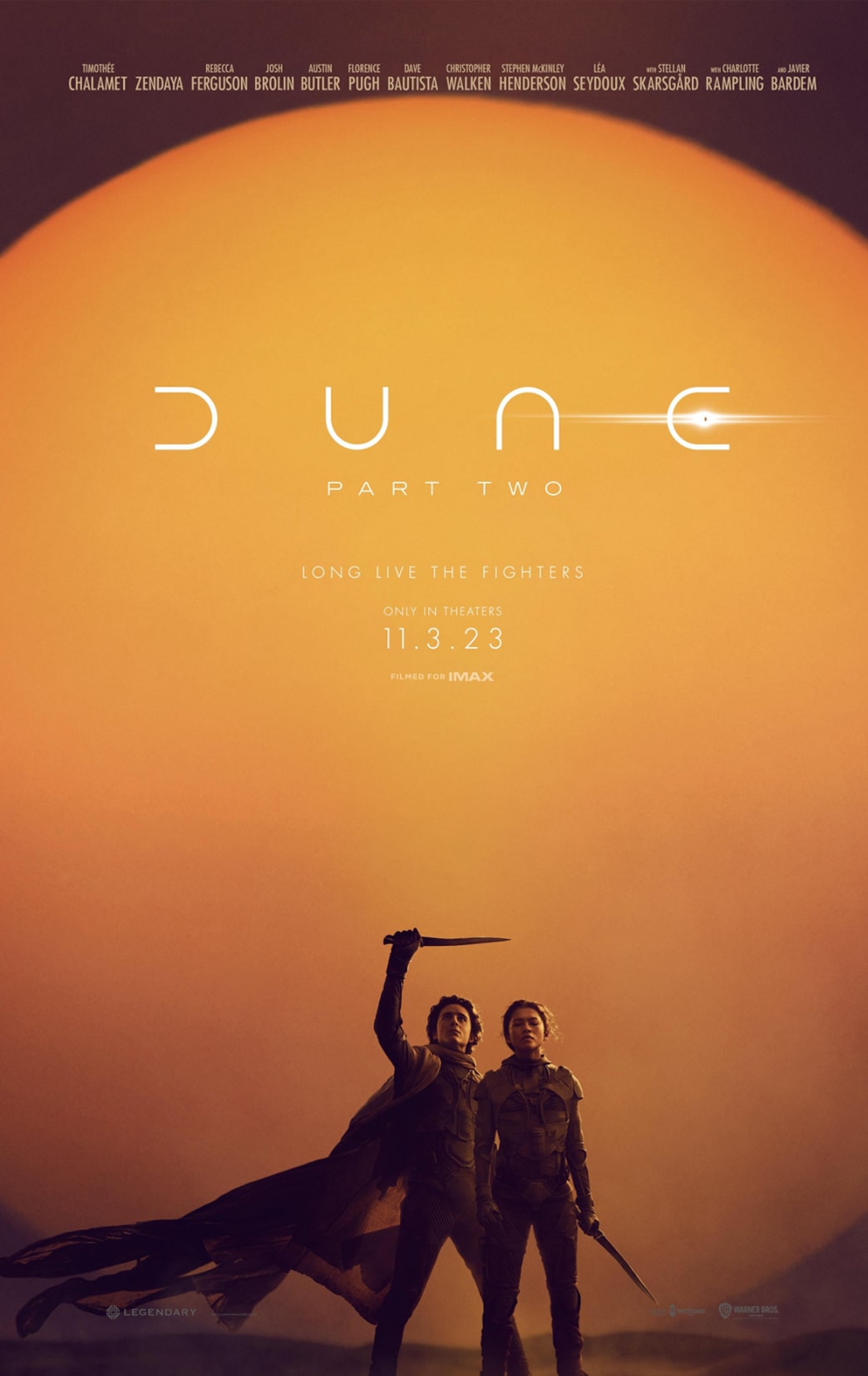 A poster for dune with two people standing in front of an orange sun.